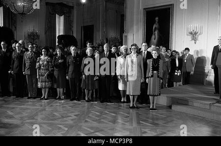 ***FILE PHOO*** BARBARA BUSH HAS PASSED AWAY (1925-2018) Washington. DC., USA, February 28, 1984 First Lady Nancy Reagan stands with Austrian First Lady Herma Kirchschlager during arrival ceremony in the East Room of the White House. The ceremony was held indoors due to a snowstorm. Standing behind Mrs. Reagan is Vice-President George H.W. Bush and his wife Barbara, and Secretary of State George Shultz and his wife Helena. Credit: Mark Reinstein/MediaPunch Stock Photo