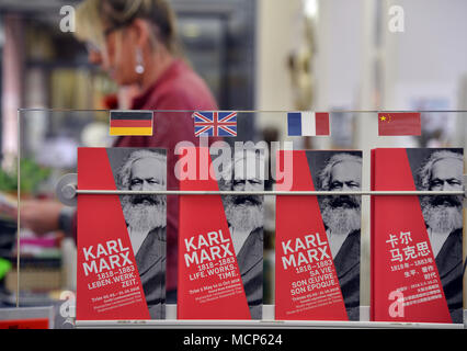 10 April 2018, Trier, Germany: Signs in four languages point to the large exhibition about the life, work, and times of the philosopher Karl Marx at the Trier tourist information. Several products have been created on the occasion of the 200th birthday of the philosopher Karl Marx. Photo: Harald Tittel/dpa