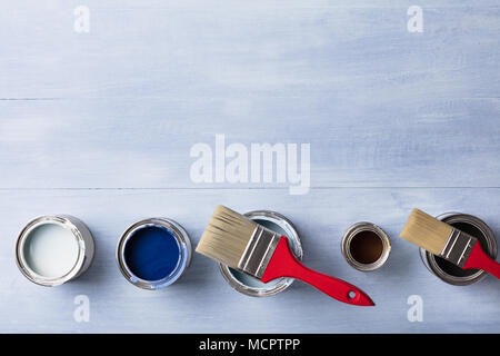 High Angle View Of Paint Can With Paintbrush On Wooden Plank Stock Photo