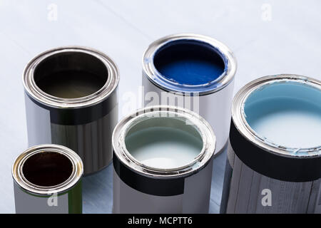 Photo Of Open Paint Cans On Wooden Plank Stock Photo