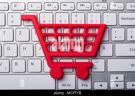 High Angle View Of Red Shopping Cart On Laptop Keypad Stock Photo