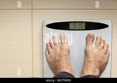 Man's leg on a scale. Stock Photo