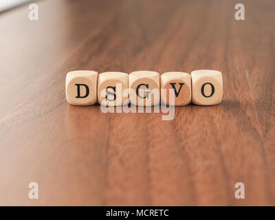 DSGVO concept image with small wooden dices on a wooden background Stock Photo