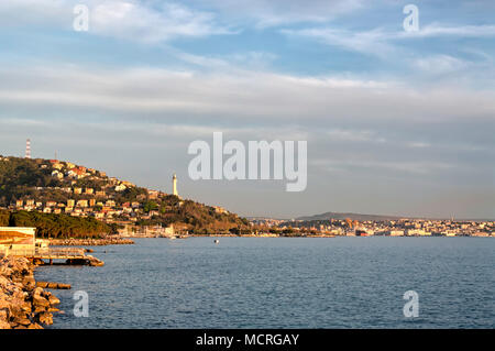 View of the beautiful Trieste with its beacon and the gulf at sunset, Italy. Romantic Italian seascape at twilight Stock Photo