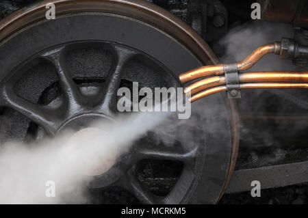 steam coming out of copper pipes on old locomotive engine Stock Photo