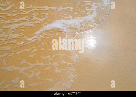 Sand beach water background. reflection of the sun on the sandy beach with sea water Stock Photo