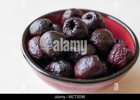 Dried Black Olive Chips / Crackers without seeds in Bowl. Organic Appetizer. Stock Photo