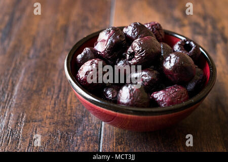 Dried Black Olive Chips / Crackers without seeds in Bowl. Organic Appetizer. Stock Photo