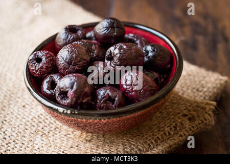 Dried Black Olive Chips / Crackers without seeds in Bowl. Organic Appetizer. Stock Photo