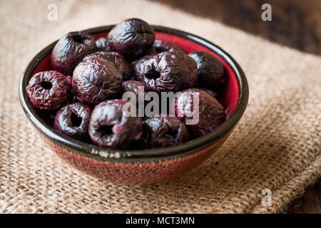 Dried Black Olive Chips / Crackers without seeds in Bowl. Organic Appetizer. Stock Photo