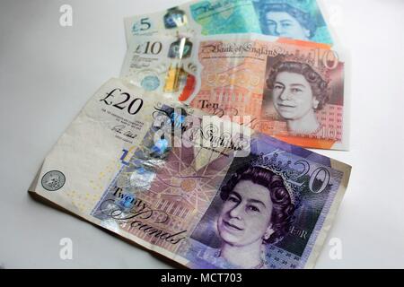 Five, Ten and Twenty Pound British bank notes. The Five and Ten notes are the new polymer style and the Twenty is the current but older paper version. Stock Photo