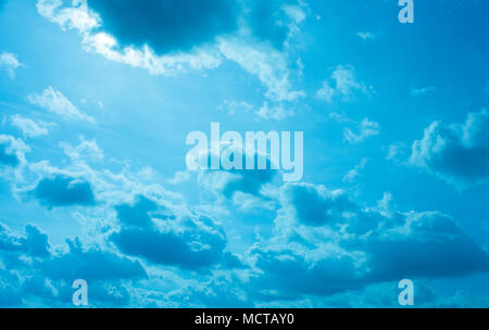 Despite dark clouds, on the blue sky  sun shines. Stock Photo