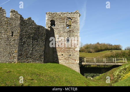 The gatehouse and curtain wall of Coity Castle and the wooden bridge over the moat Stock Photo