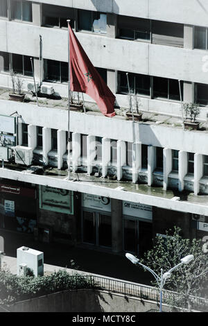 Old fashioned picture using a filter of the Moroccan flag outside an office building in Casablanca, Morocco Stock Photo