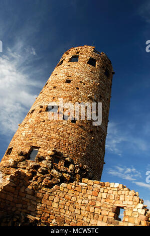 The Watchtower in Grand Canyon National Park, AZ reflects the golden hue of the setting sun. Stock Photo