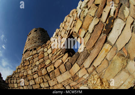 The Watchtower in Grand Canyon National Park, AZ reflects the golden hue of the setting sun. Stock Photo