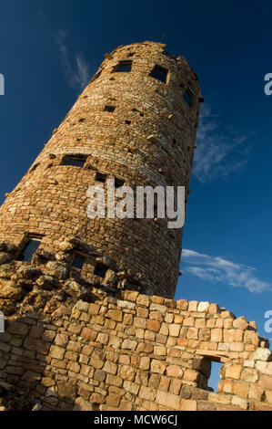 The Watchtower in Grand Canyon National Park, AZ reflects the golden hue of the setting sun. Stock Photo