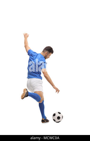Full length rear view shot of a soccer player kicking a football isolated on white background Stock Photo