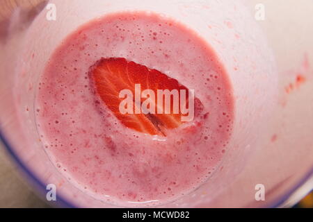 Halved Strawberry in Milk Shake Closeup Top View Stock Photo