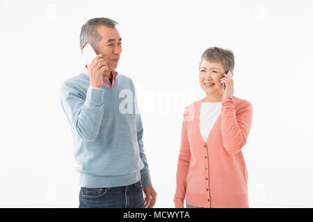 Senior couple talking on smart phone Stock Photo