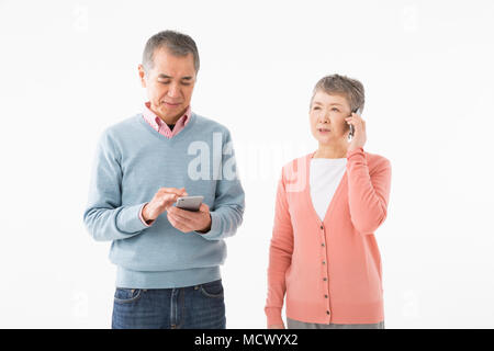 Senior couple talking on smart phone Stock Photo