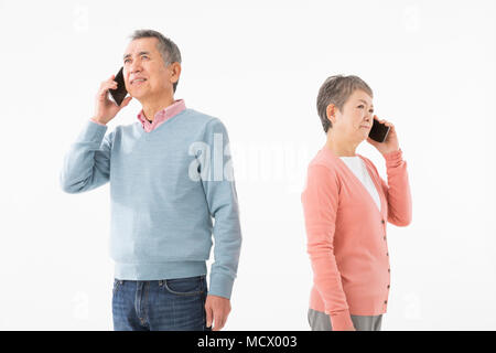 Senior couple talking on smart phone Stock Photo