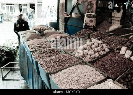 Moroccan vendor behind his vegetables, herbs and nuts on the old souk of Casablanca, Morocco Stock Photo