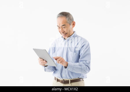 Senior man using tablet Stock Photo