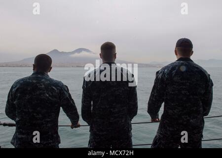 180304-N-QR145-043 NAPLES, Italy (March 4, 2018)  Sailors aboard the Blue Ridge-class command and control ship USS Mount Whitney (LCC 20) observe Mount Vesuvius as the ship departs Naples, Italy, March 4, 2018. Mount Whitney, forward-deployed to Gaeta, Italy, operates with a combined crew of U.S. Navy Sailors and Military Sealift Command civil service mariners.  (U.S. Navy photo by Mass Communication Specialist 3rd Class Krystina Coffey/Released) Stock Photo