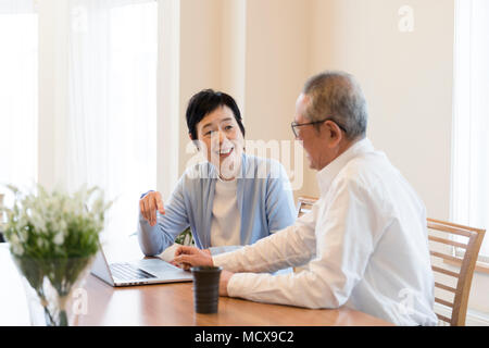 Senior couple using laptop together Stock Photo