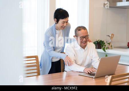 Senior couple enjoying video chatting on laptop Stock Photo