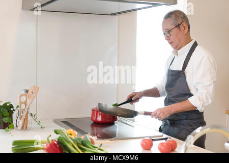 Scene of Senior man cooking Stock Photo