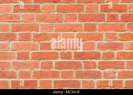 Red brick wall background closeup pointed with lime mortar Stock Photo