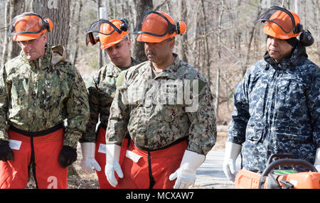 Members of the New York Naval Militia listen to chain saw use instructor 1st Sgt. Robert Rathbun, a member of the New York Guard's 102nd Engineers at Camp Smith Training Site, Cortlandt Manor, N.Y., Mar. 6, 2018 . The New York Naval Militia consists of members of the Navy and Marine Corps Reserve who volunteer to report for state duty when called. The New York Guard is the state's volunteer response force. Two hundred members of the New York Army and Air National Guard, and New York Naval Militia,  and N.Y. Guard have been activated following last Friday’s nor’easter to local emergency service Stock Photo