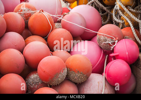 Red spherical plastic floats of fishing nets lay in port Stock Photo