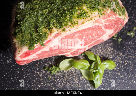 Raw prime ribeye roast prepared with a parley and salt rub ready to be roasted in the oven Stock Photo