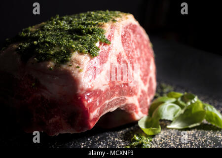 Raw prime ribeye roast prepared with a parley and salt rub ready to be roasted in the oven Stock Photo