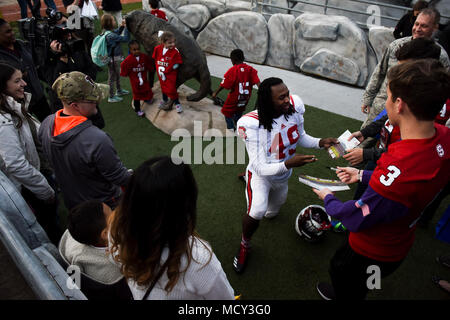 A.J. Thompson, Jr., North Carolina State University defensive back, signs autographs for Seymour Johnson Air Force Base, North Carolina, and Fort Bragg, North Carolina, families following a team practice, March 23, 2018, at NC State University in Raleigh, North Carolina. The families, who currently or are soon expecting to have a member deployed, were invited to the campus to get a full-blown sporting experience to help them cope with their separation. Stock Photo