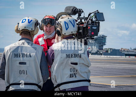 ATLANTIC OCEAN (March 27, 2018) Aviation Ordnanceman 2nd Class Zachary Lott, from Madison, Florida, gives an interview to civilian media about his job in the Navy and life aboard the aircraft carrier USS George H.W. Bush (CVN 77). The ship is underway conducting sustainment exercises to maintain carrier readiness. Stock Photo