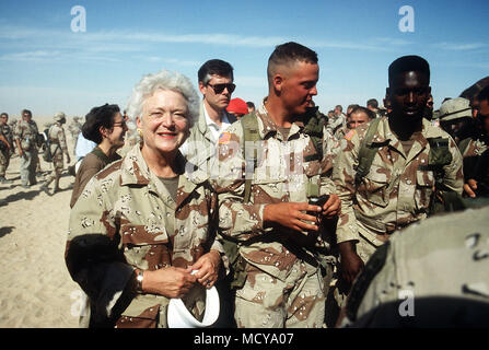 Members of the 197th Brigade, 24th Infantry Division escort Barbara Bush after she and President George Bush arrived in camp for a Thanksgiving Day visit during Operation Desert Shield. Stock Photo