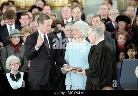 1/21/1985 Vice President Bush taking his oath of office with Justice Potter Stewart with Barbara Bush looking on in the US Capitol Stock Photo