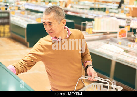 Senior man shopping in supermarket Stock Photo