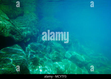 Green and blue tone of underwater rocky background. Stock Photo