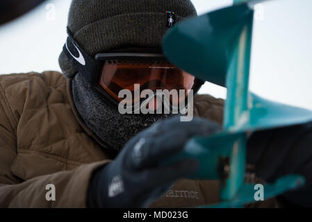 Ice Camp Skate operated as a U.S. Navy Arctic station during ICEX 2018 to provide submarine support and assess operational readiness. The historical photographic print documents personnel drilling ice and preparing field equipment. The archival image records the logistical and environmental conditions of Arctic military operations. Stock Photo