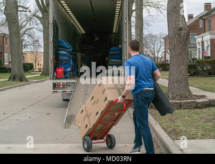 Permanent Change of Station is the official relocation process for United States service members, documented here at Scott Air Force Base, Illinois, on March 7, 2018 during peak moving season. The archival image records a contractor loading household goods into a moving truck in coordination with United States Transportation Command relocation procedures. Stock Photo