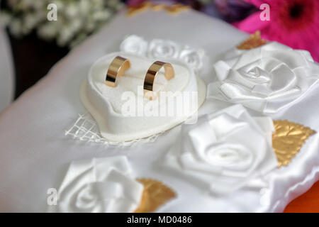 Golden wedding rings on the table before wedding ceremony with space for text Stock Photo