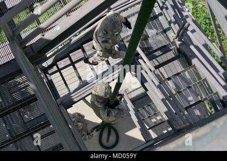 A Royal Marine Commando fast ropes from a Royal Air Force ...