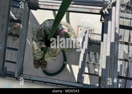 A Royal Marine Commando fast ropes from a Royal Air Force ...