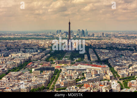 Aerial view of Parisian skyline, Eiffel Tower and La Defense district on background as seen from Montparnasse Tower in Paris, France. Stock Photo