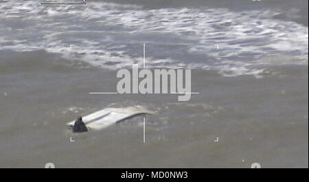 A vessel capsizes near the Port Mansfield jetties near South Padre Island, Texas, Mar. 29, 2018. The Coast Guard responded with an HC-144 Ocean Sentry aircrew, a rescue boat from Station South Padre Island, and the Coast Guard Cutter Jacob Poroo. Stock Photo